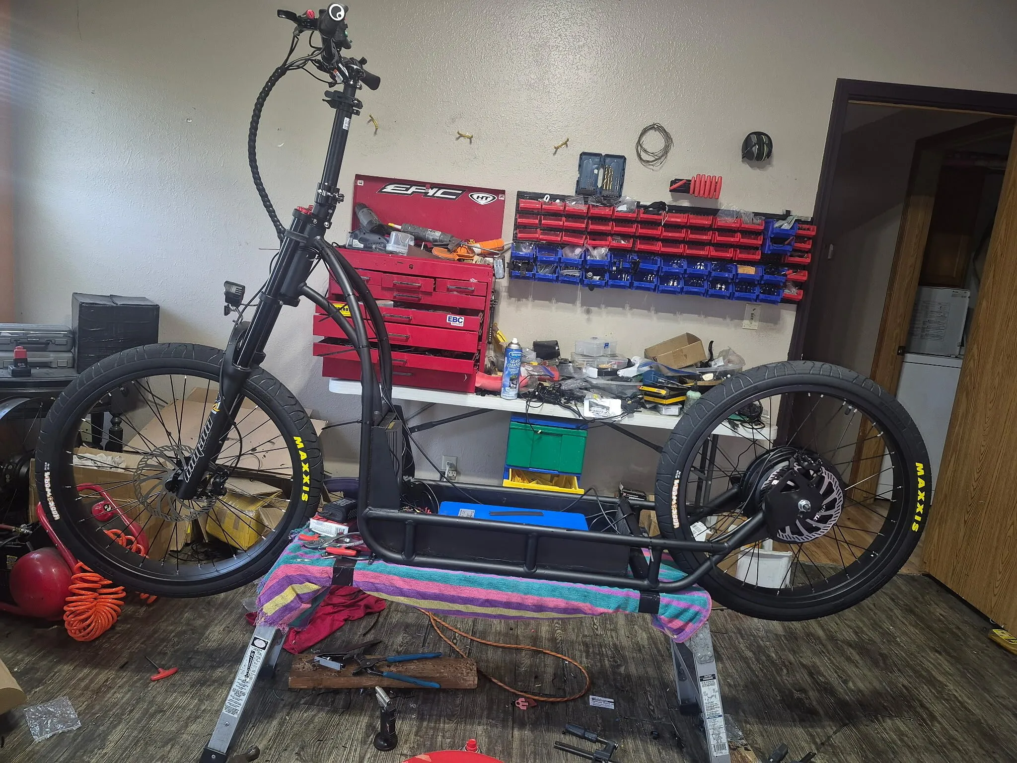 Electric bike frame powder coated satin black, assembled on a work stand