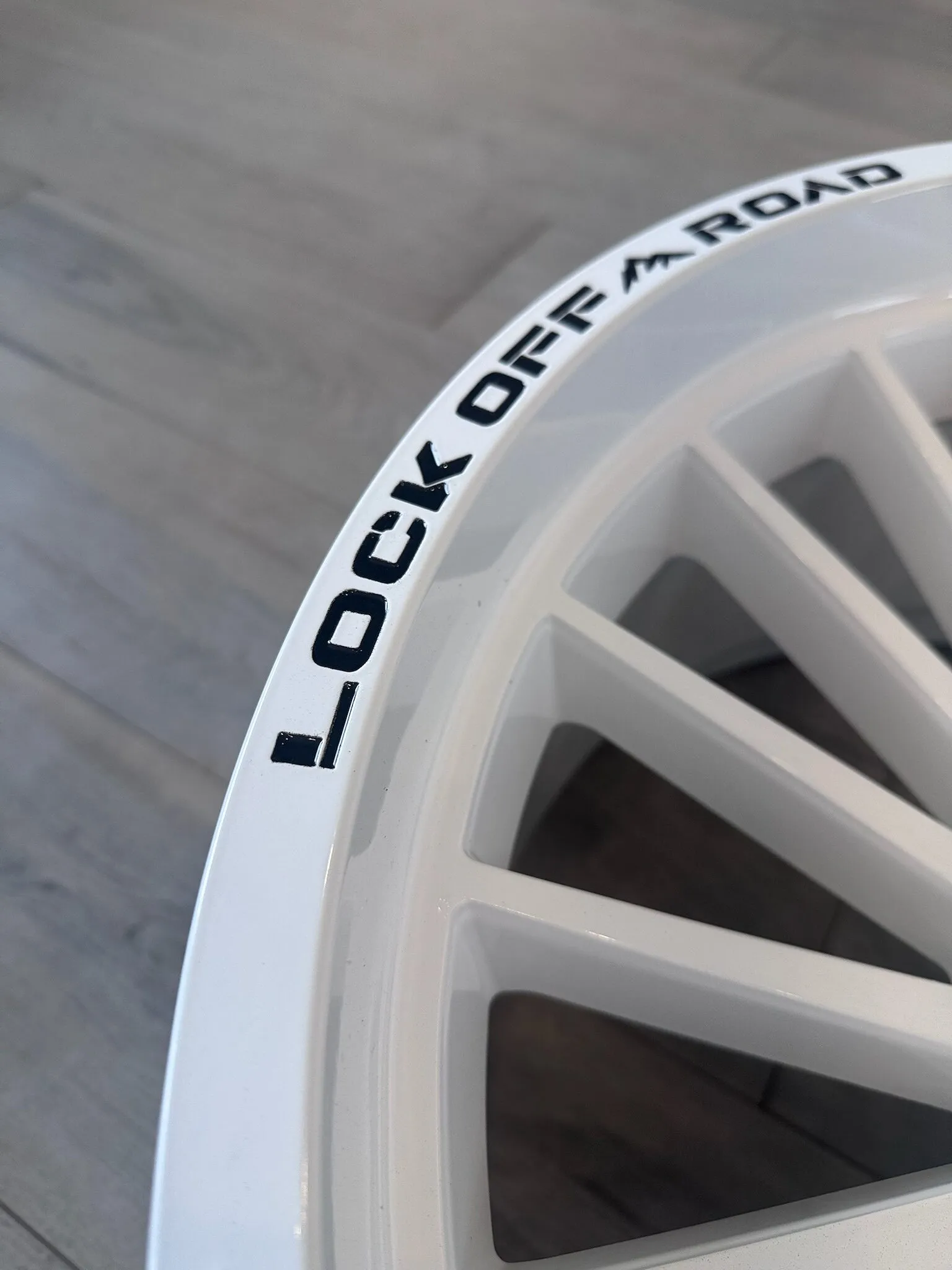 Close-up of the lip and spokes of a white powder-coated wheel